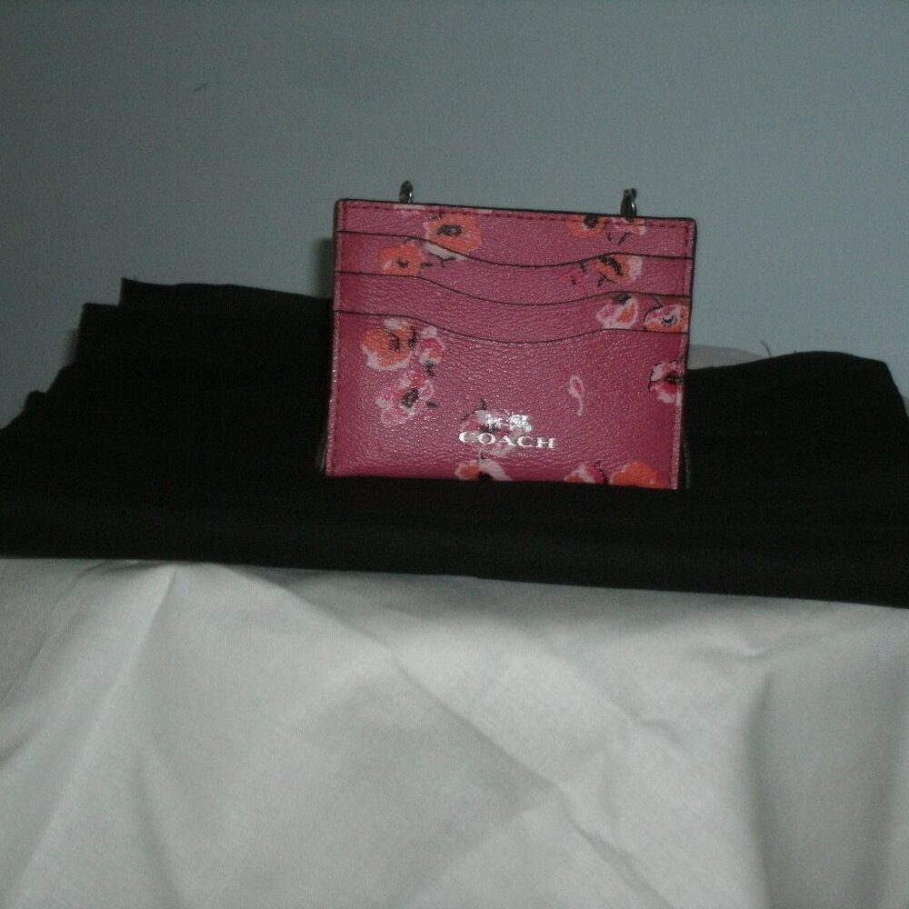 A pink floral Coach credit card holder is a chic and practical